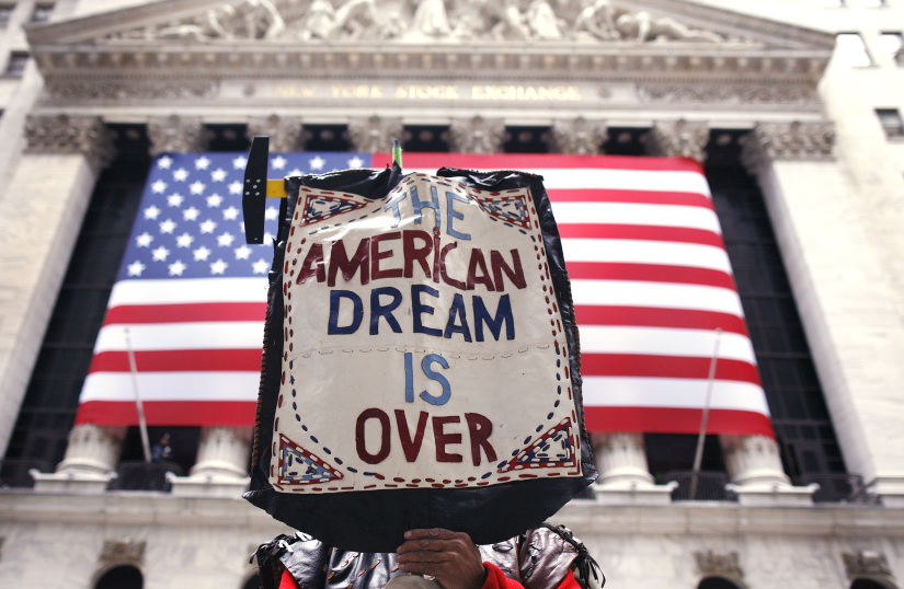 A demonstrator holds a sign during a rally outside Wall Street in New York