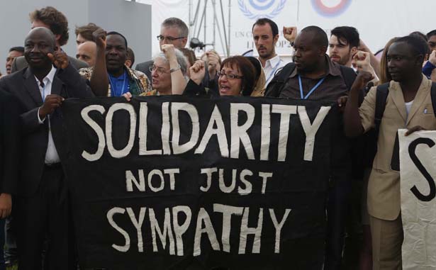 Делегаты из разных стран держат баннер с надписью "Солидарность, а не просто симпатии." на конференции, посвященной изменению климата в Перу, декабрь 2014. © thenation.com