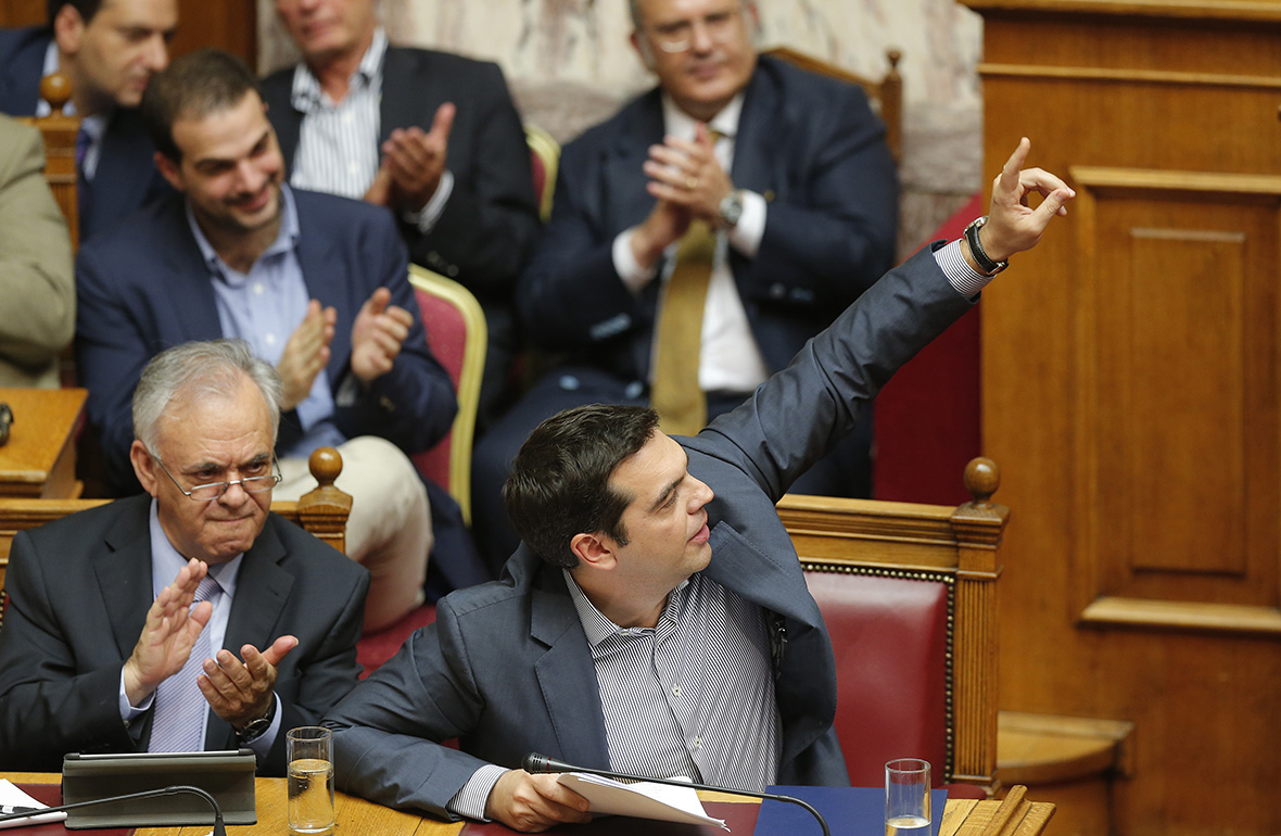 Greek Prime Minister Alexis Tsipras (1st row, R) and Deputy Prime Minister Yannis Dragasakis (1st row, L) attend a parliamentary session in Athens, Greece, July 10, 2015. Greek Prime Minister Alexis Tsipras appealed to his party's lawmakers on Friday to back a tough reforms package after abruptly offering last-minute concessions to try to save the country from financial meltdown.