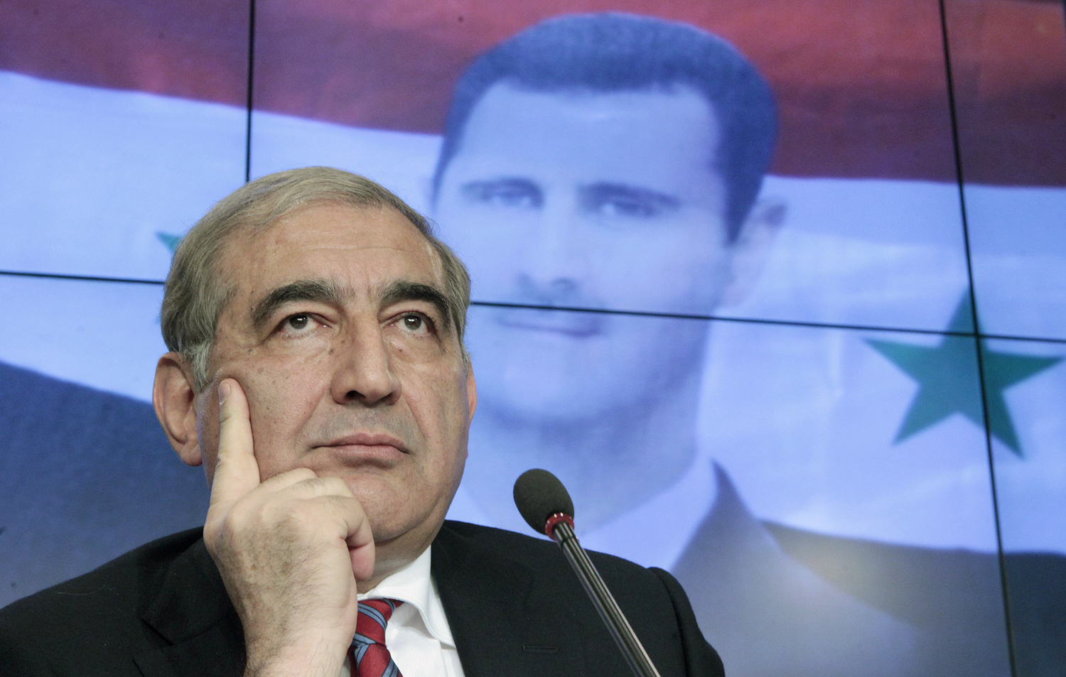Qadri Jamil, Syria's deputy prime minister for economic affairs, listens during a news conference in Moscow, Aug. 21, 2012. The Syrian government said on Tuesday foreign military intervention in Syria was "impossible" because it would lead to a conflict beyond the country's borders.